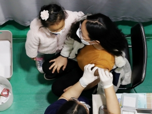 28일 서울 서대문구 북아현문화체육센터에 마련된 신종 코로나바이러스 감염증(코로나19) 백신 예방접종센터에서 한 어린이가 백신접종 전 긴장하는 엄마를 안아주고 있다. 뉴스1